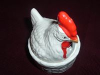 White rooster on a white basket